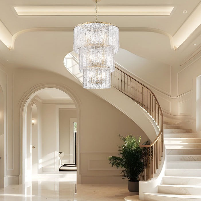 Foyer lighting - crystal chandelier over curved staircase | Lighting House Orillia